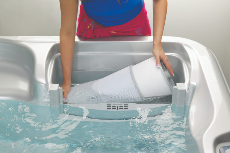 67 Hot Tub Tips Only Spa Experts Know - Take A Break Spas And Billiards Blog Woman Installing A Large White Hot Tub Filter In The Filter Compartment Of A Jacuzzi Spa